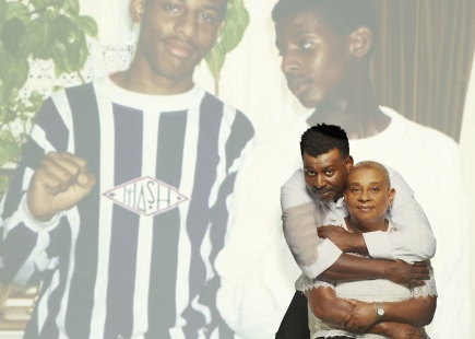 Embargo 16th November 20 Lost for Words A Royal London exhibition with Rankin Doreen and Stuart Lawrence pictured standing next to a projection of their son brother who they lost to murder